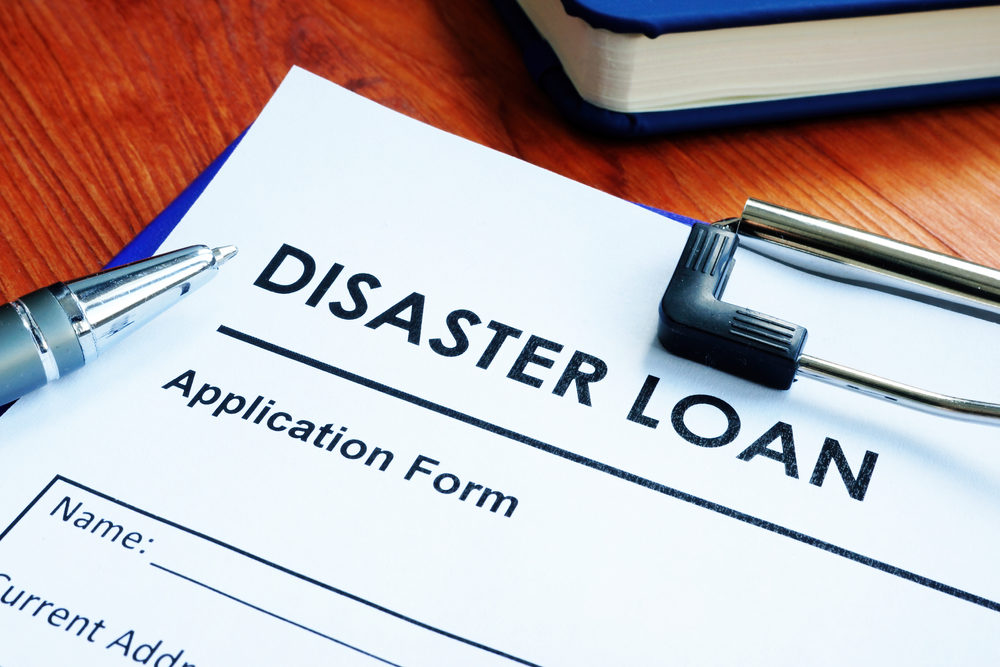 SBA Disaster Loans vs. Insurance Coverage After a Louisiana Hurricane SBA disaster loan application form on the wooden surface.