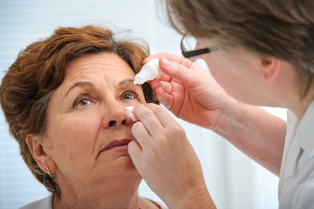 CDC Reports More People Dying, Losing Their Eyes Due to Eye-Drop Infections Doctor helps the patient and gives the eye drops