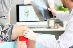 Doctor with patient holding xray shot prescribing treatment closeup