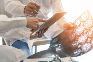 brain and neurological surgeon with digital tablet working in hospital discussing a brain scan