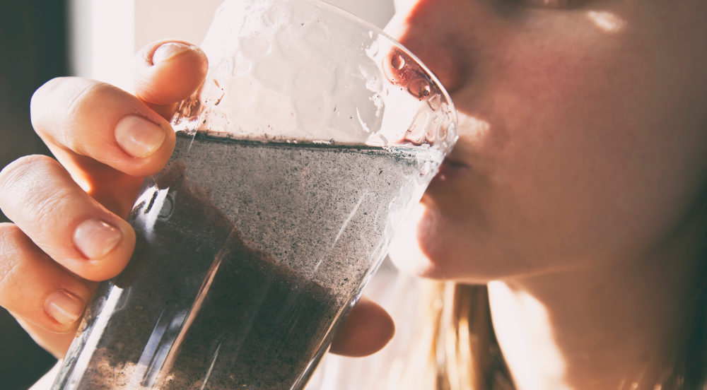 Camp LeJeune Military Base Water Contamination – PACT ACT passes in Senate woman is drinking dirty water from the glass cup