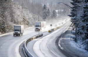 eighteen-wheeler driving on a highway in the winter