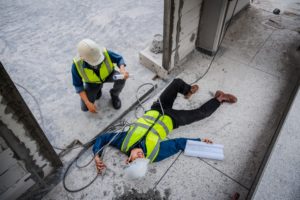 worker attending to an electrocuted coworker at a jobsite