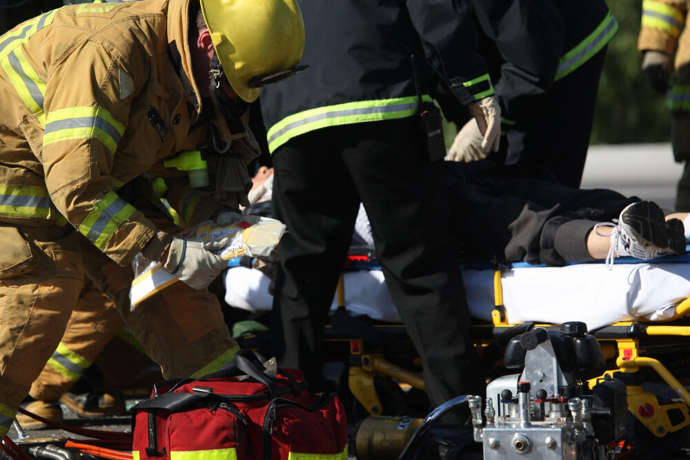 emergency services crew tending to a accident victim on a stretcher