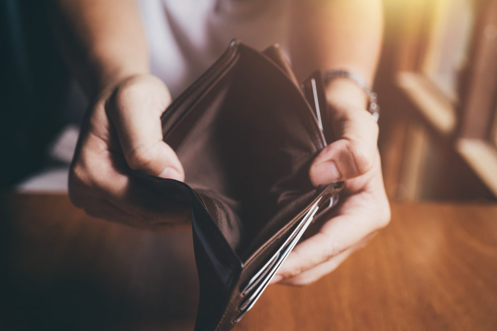 A man holds open an empty wallet