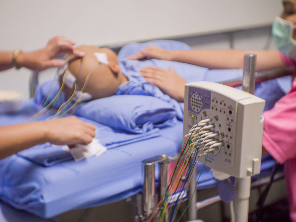 Blurred of nurse and patient with encephalography electrode in clinic, Electroencephalogram (EEG)