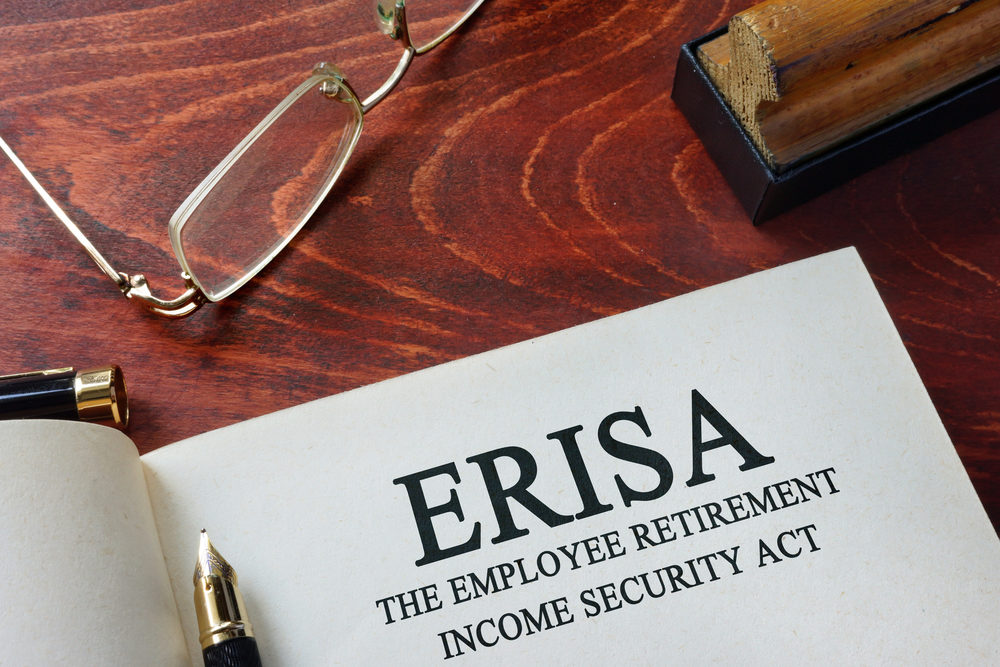 Page with ERISA The Employee Retirement Income Security Act of 1974 on a table.