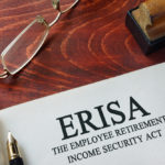 Page with ERISA The Employee Retirement Income Security Act of 1974 on a table.