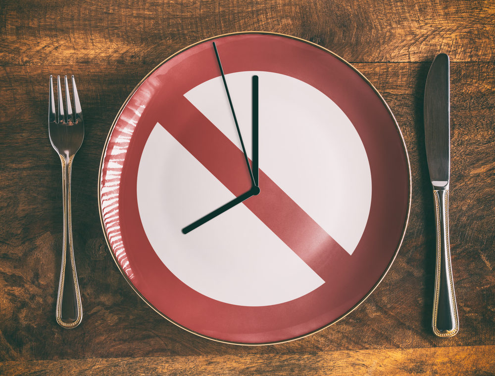 Intermittent Fasting Faces Criticism from Recent Study Skip breakfast concept with no symbol and clock on plate