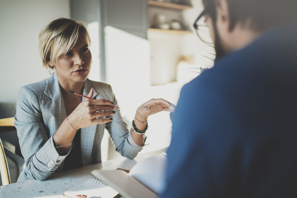 Who Buys Structured Settlement Payments? A young businesswoman talks with a man across a table