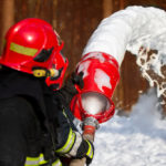 Firefighters extinguish a fire with foam.