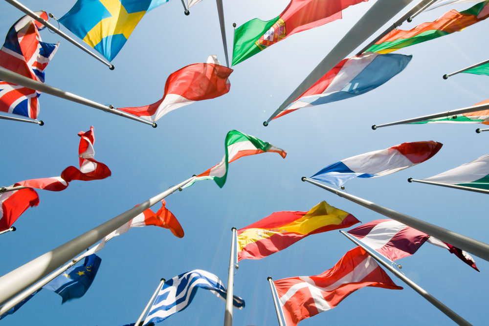 Various international flags waving from flagpoles