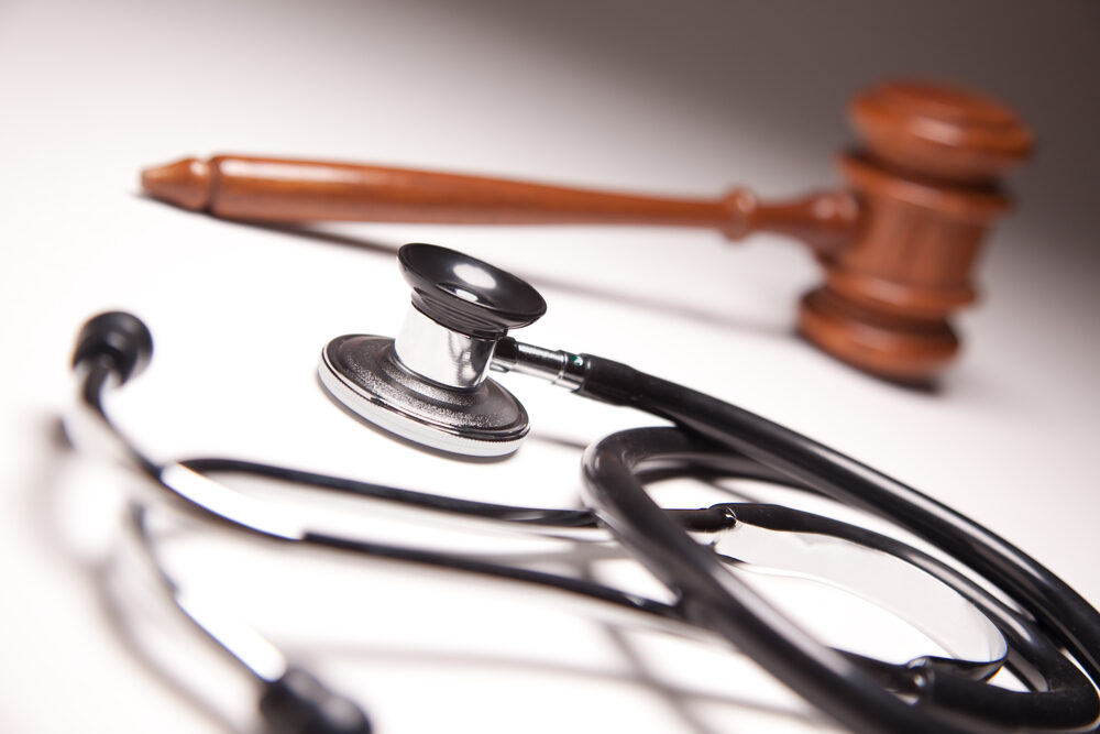 Gavel and Stethoscope on Gradated Background with Selective Focus