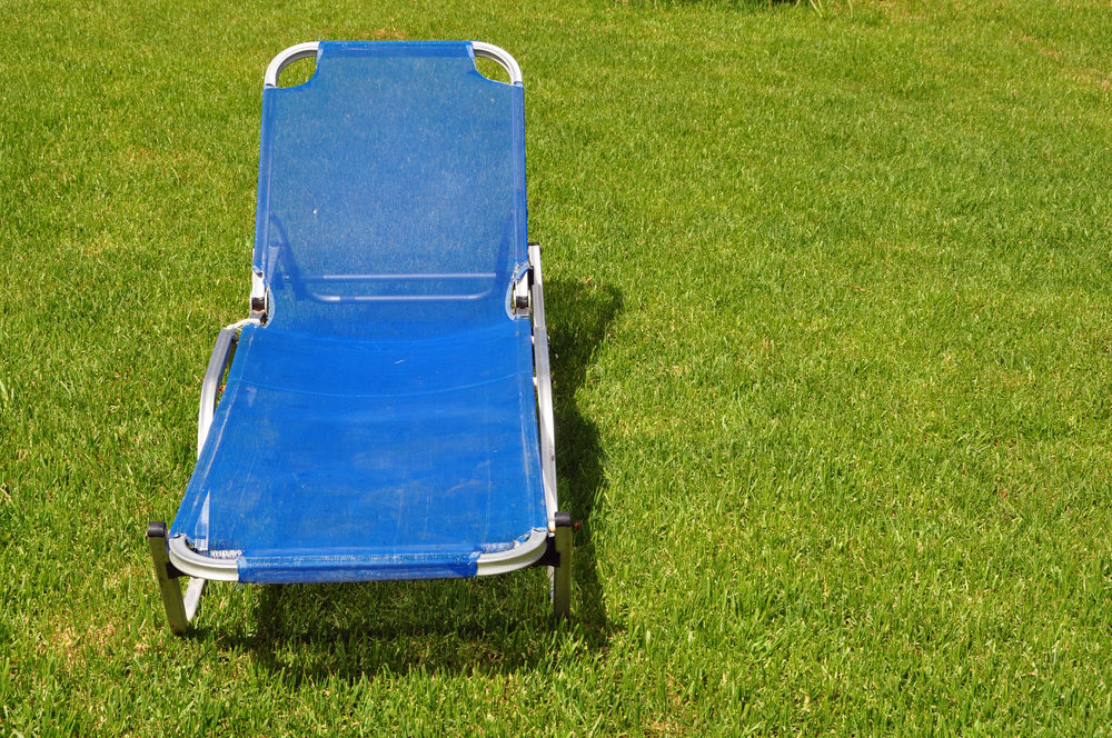 Lawn chair on green grass background.