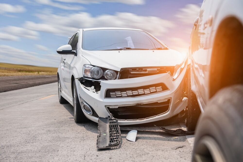 view of front of a white car damaged by an auto accident