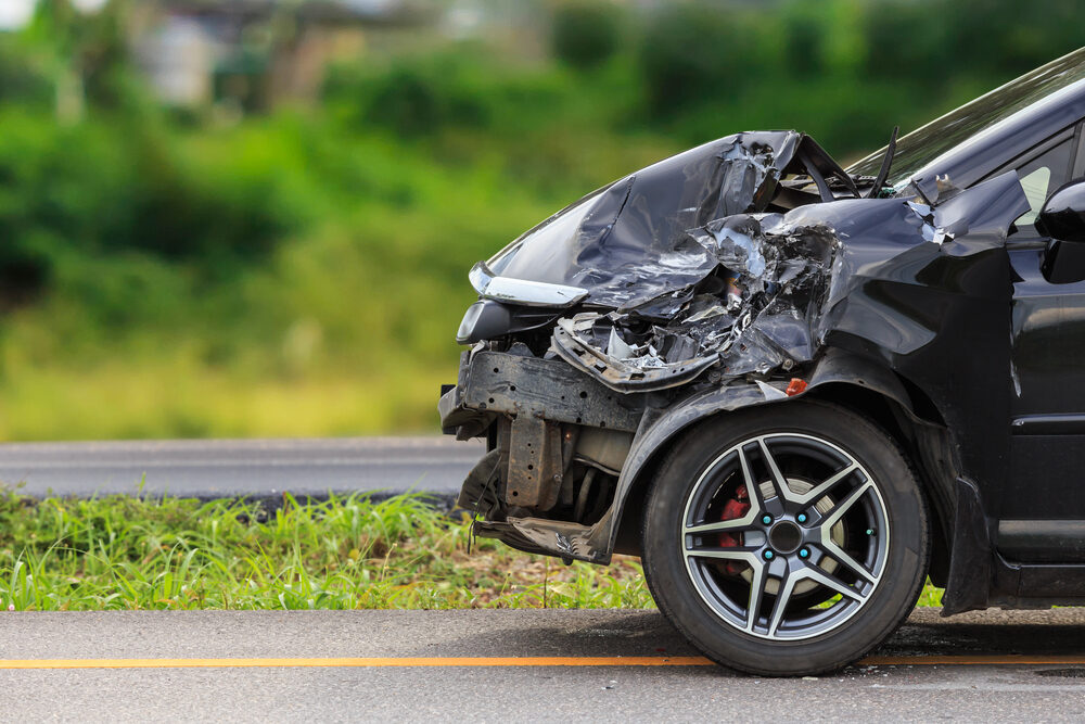 Front of black car get damaged by accident on the road