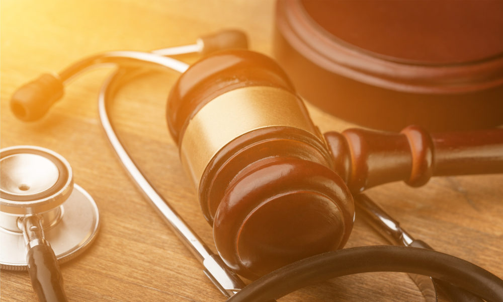 Gavel and stethoscope on wooden background