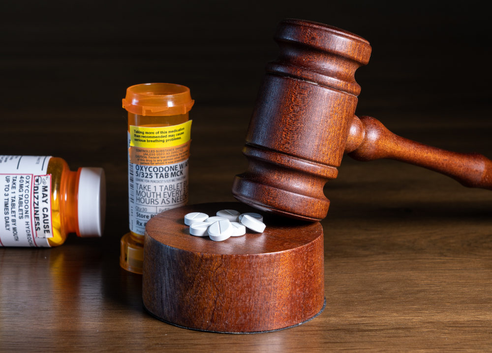 Prescription bottle for pills and tablets with judge's gavel for court decision