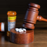 Prescription bottle for pills and tablets with judge's gavel for court decision