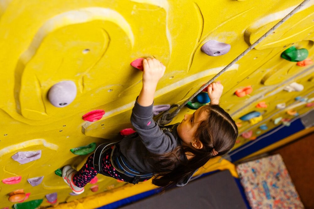 Can You Still Sue for an Injury After Signing a Waiver in Virginia? little girl climbing a rock wall indoor.
