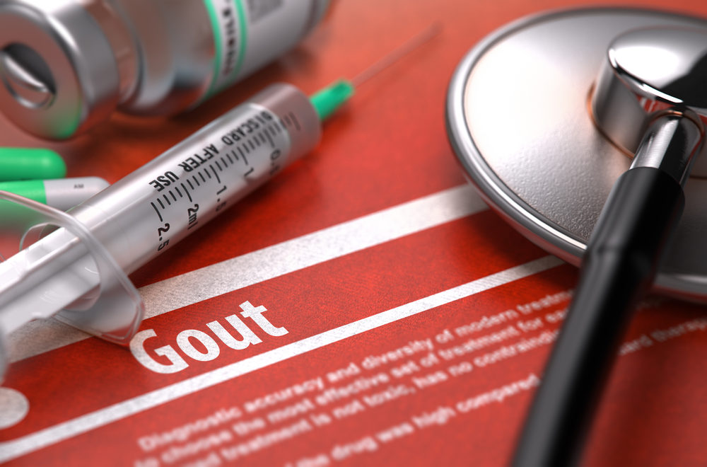 Gout - Printed Diagnosis with Blurred Text on Orange Background and Medical Composition - Stethoscope, Pills and Syringe.