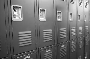 closeup of grey school lockers in locker room