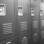 closeup of grey school lockers in locker room