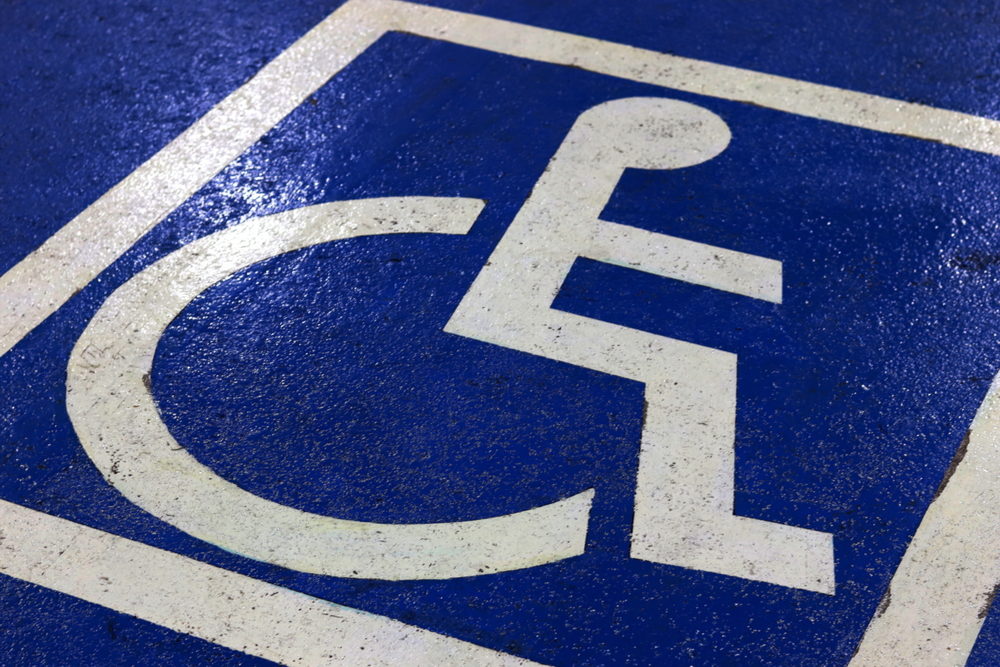 A blue and white painting of a wheelchair, indicating a disabled parking spot