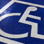 A blue and white painting of a wheelchair, indicating a disabled parking spot