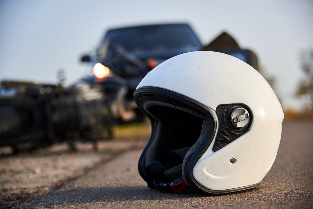 helmet and motorcycle on road after an accident