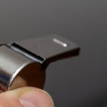 hand holding metal whistle closeup 