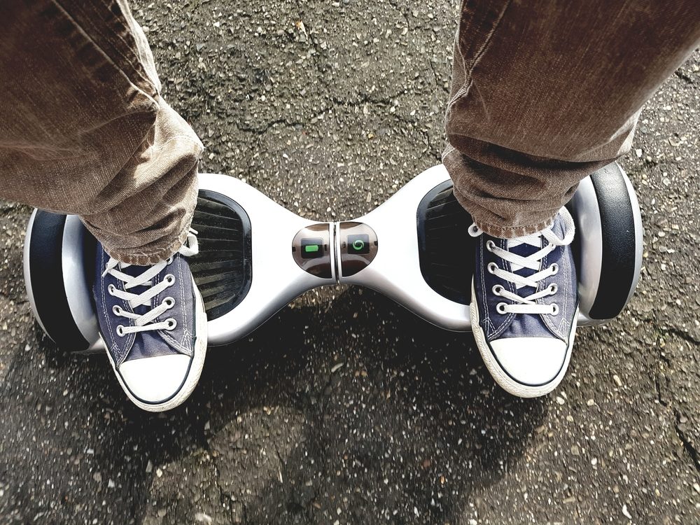 Top-down view of a hoverboard being ridden on asphalt