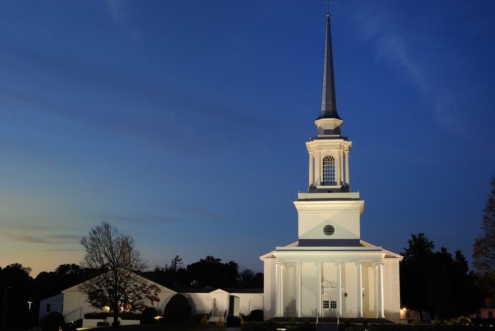 A Southern Baptist Church illuminated at twilight.