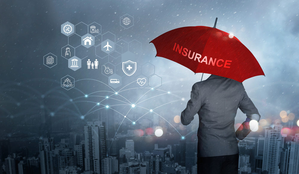 Insurance concept, Businessman holding red umbrella on falling rain with icons for business, health, financial, life, family, accident and logistics insurance on city background