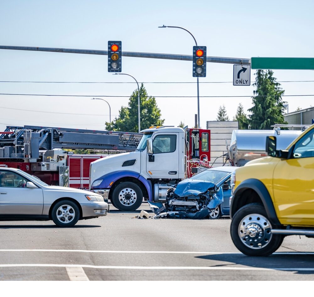 car accident crash involving a semi truck with trailer at a city street intersection with emergency services on site