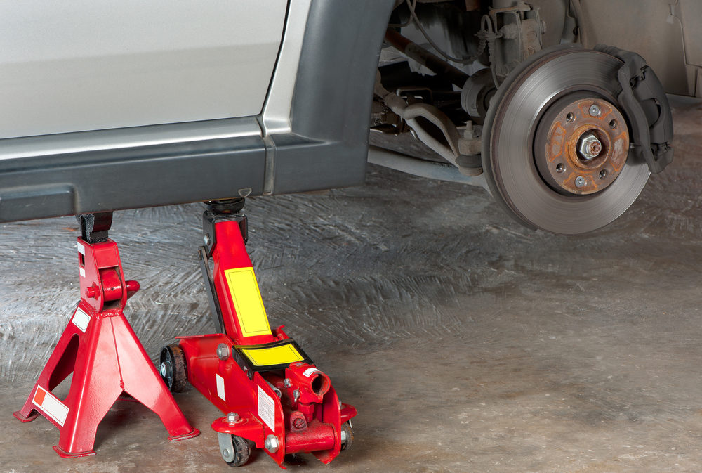 Extra safety measures are taken by using a hydraulic jack and jack stand to lift up a vehicle.