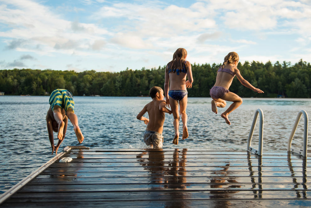 Kids jumping into the lake