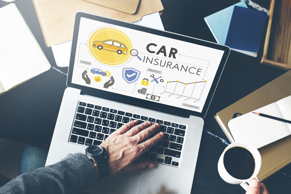 How Much Auto Insurance Do I Need To Be Protected? man on laptop with car insurance concept on screen