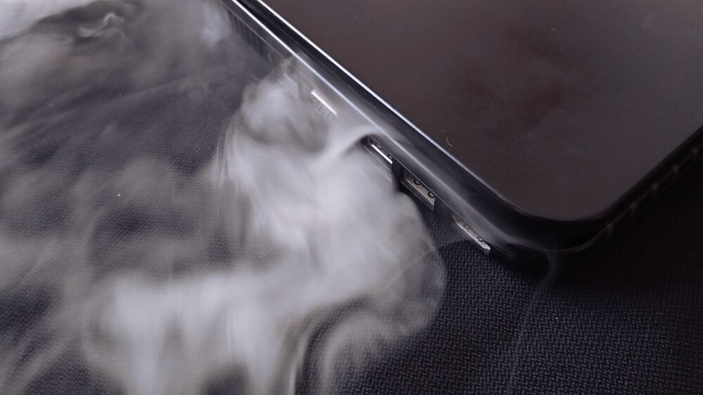 Lithium Battery Explosions, Fires, and Dangers smoke coming out of a black laptop from lithium battery malfunction