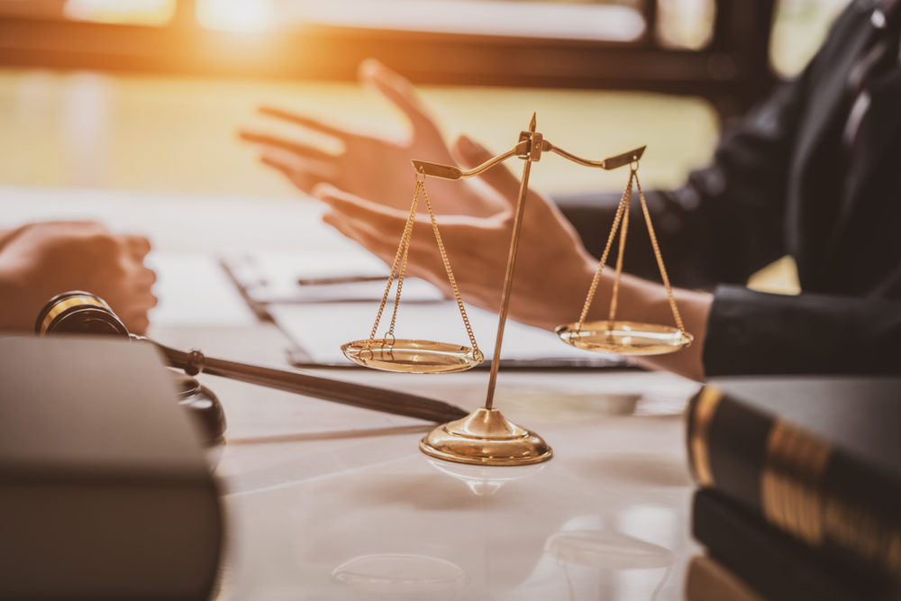 closeup of an attorney at desk going over a case with a client