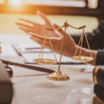 closeup of an attorney at desk going over a case with a client