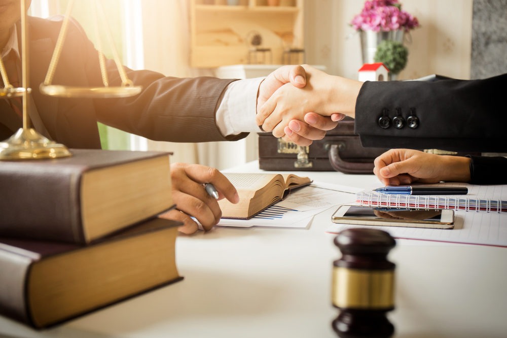 Handshake between a male attorney and a female client