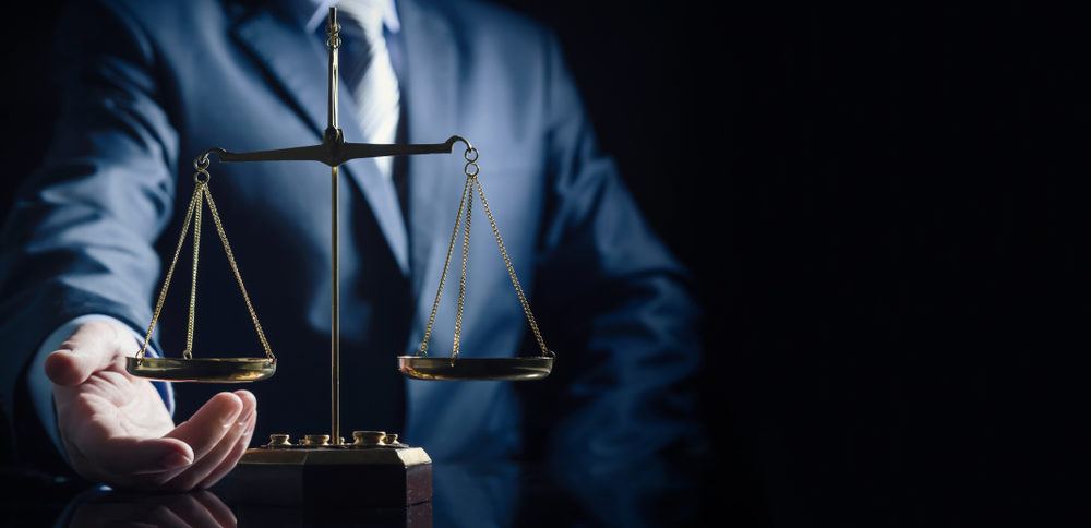 Academy of Certified Trial Lawyers of Minnesota Issues Judicial Endorsements Weight scale of justice, lawyer in background