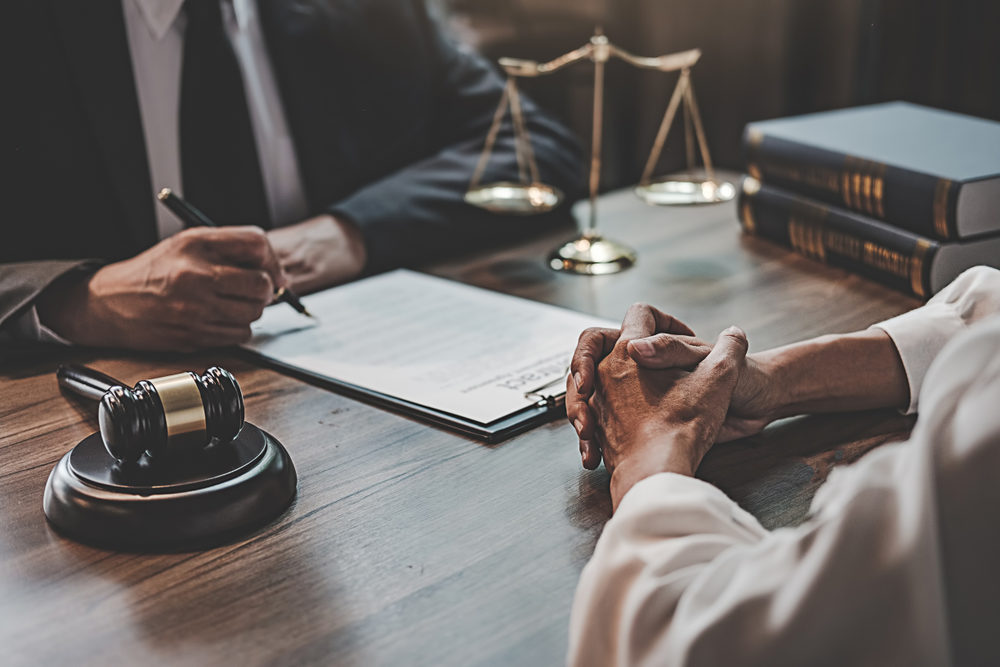 Why It’s Important To Hire a CRPS Lawyer Judge gavel with Justice lawyers having team meeting at law firm background.