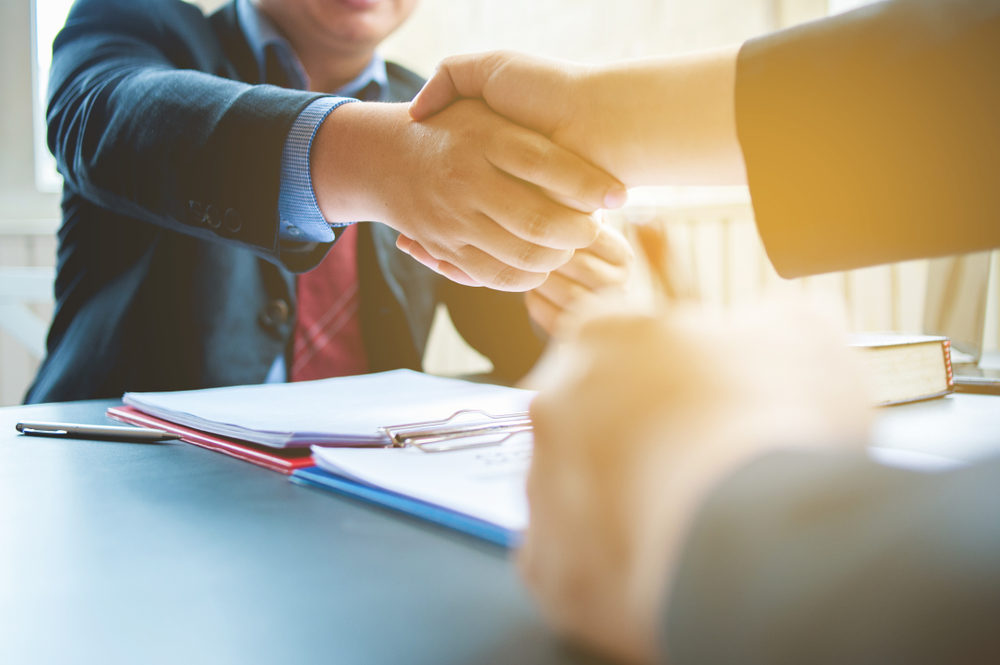 Lawyers and businessmen shaking hands in business After signing the legal contract