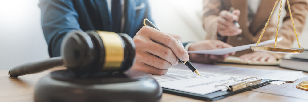 closeup of a Lawyer working with a partner at law firm.