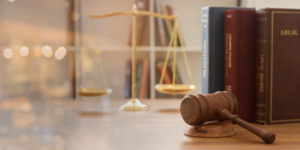 Judge gavel with law books and scales of justice.