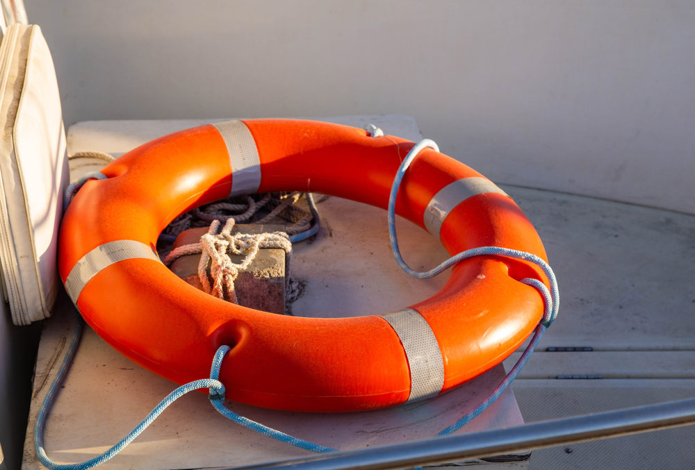 circle for saving people on the water orange color lies on the back of the boat. 