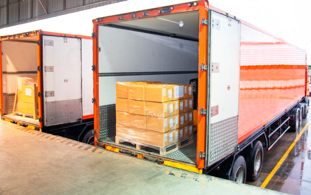 Liability for Truck Accidents: Cargo Loading Crews Pallet stacked with boxes sitting in the back of a truck at a loading dock