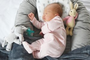 Sleeping white caucasian newborn baby closeup on lounger